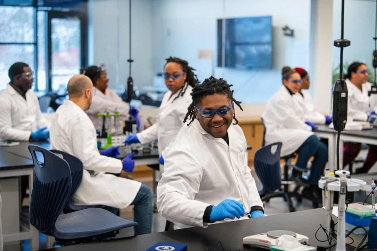 Students in white coats in a laboratory. 