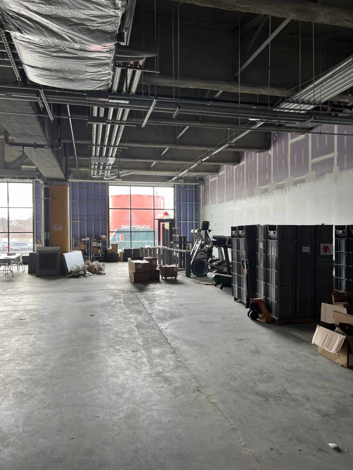 A photo of a nearly empty room under construction with random equipment scattered around. 